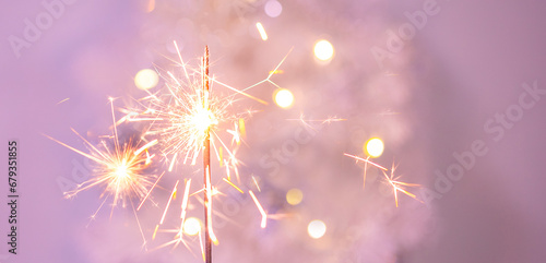 Beautiful sparkles from sparklers on the background of New Year s bokeh  Christmas mood  glitter  festive background.