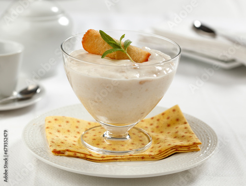 Custard apple and vanilla bavarois served with almond cookies.. photo