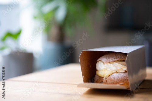 Traditional Swedish pastry, known as semla, that is still in the box from the bakery. Photo taken in Sweden.
