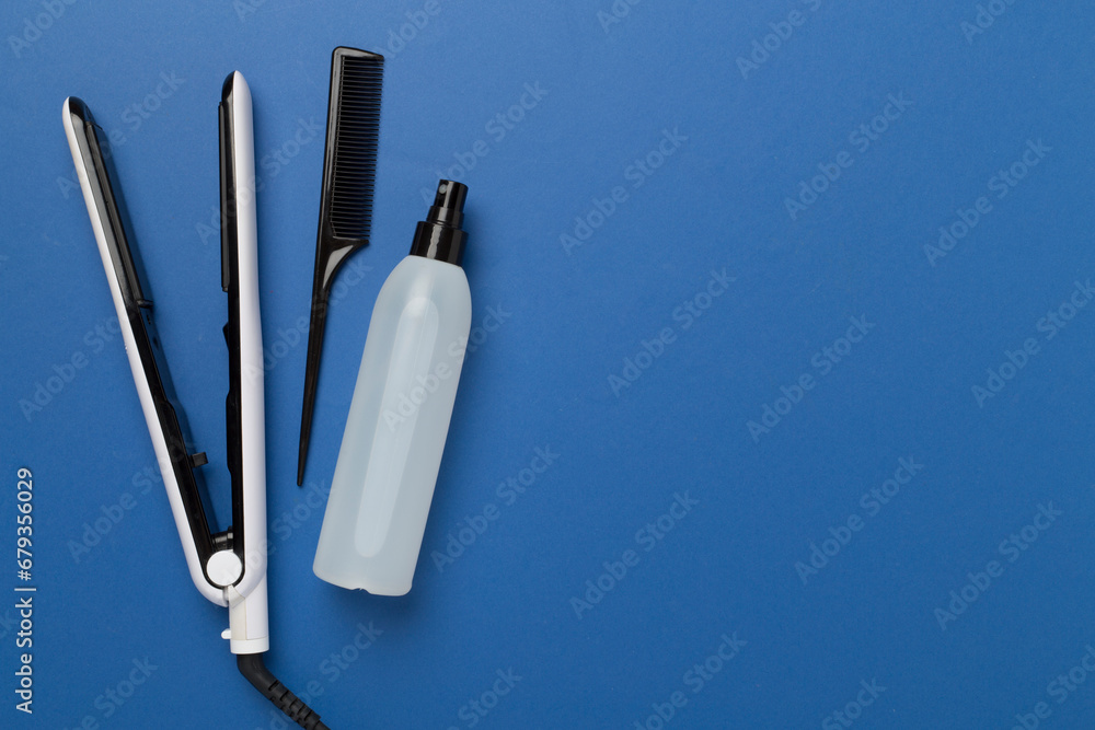 Hair straightener with thermo protection on color background, top, view Hair straightener with thermo protection on color background, top, view