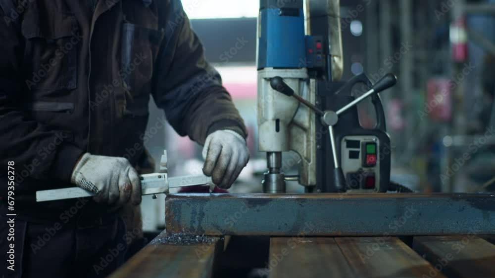 Closeup capture details factory worker take a metal and fixed something he wearing protective gloves Closeup capture details factory worker take a metal and fixed something he wearing protective gloves