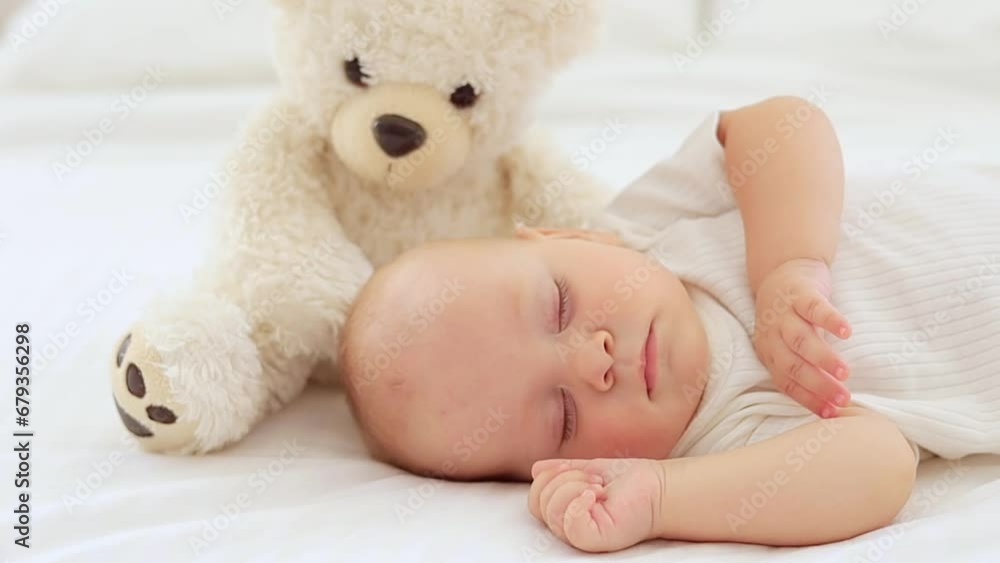 cute little newborn baby sleeping with a teddy bear, sweet healthy baby sleep in a white crib, a place for text cute little newborn baby sleeping with a teddy bear, sweet healthy baby sleep in a white crib, a place for text