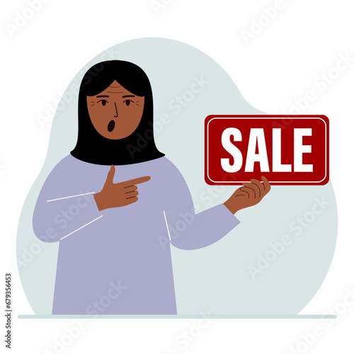 A woman holds a banner with the text sale. Points a finger at the text. The concept of a discount, a special offer in a store or a bank, an advertising flyer.