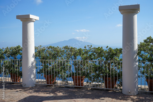 View to mount Vesuvio near Naples and Pompei from beautiful mediterranean Town Sorrento. Vesuvio framed by  green hedge and pillars photo