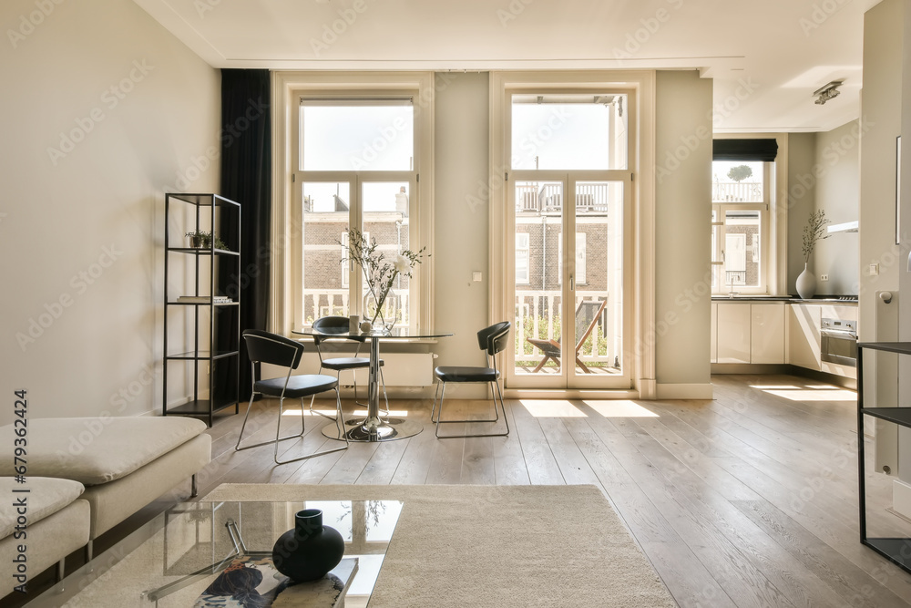 Fototapeta premium a living room with wood flooring and white walls, including two couches and a coffee table in the corner