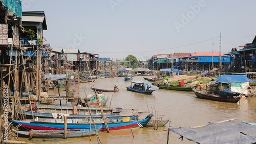 Panorama of a river along an Asian village on stilts