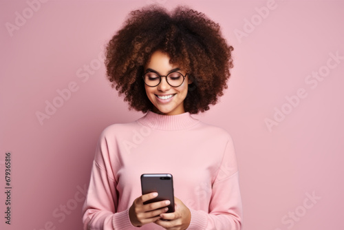 Wallpaper Mural Studio portrait of beautiful African American woman with smartphone in pink clothes against pink background. Positive girl with Afro haircut texting message, enjoying online communication, using app. Torontodigital.ca