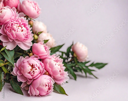 Fresh bunch of pink peonies and roses with a pink background