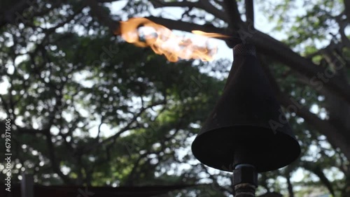 Tiki torch burning slow motion Maui (ID: 679371606)