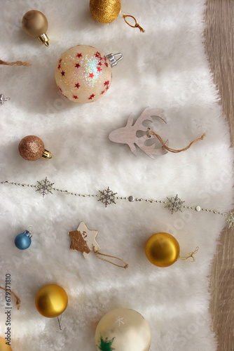 Various colorful Christmas oranments and white faux fur blanket. Top view. photo