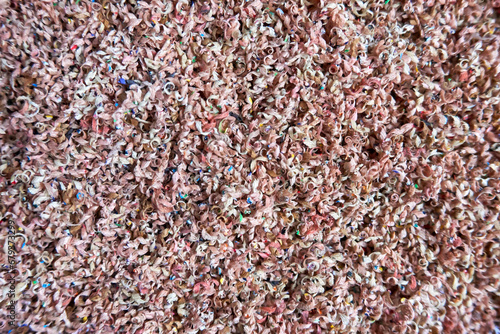 Abstract greyscale texture of intertwined pencil shavings and dust. Highly detailed macro shot. Fine chaotic pattern and visual texture. Background filler. High resolution image.