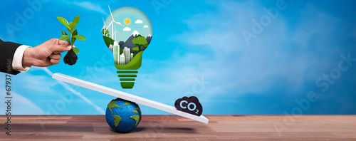 фотографія Businessman balance light bulb on scale with CO2 emission icon, demonstrate ESG commitment and environmental conservative idea to carbon reduction through clean energy technology