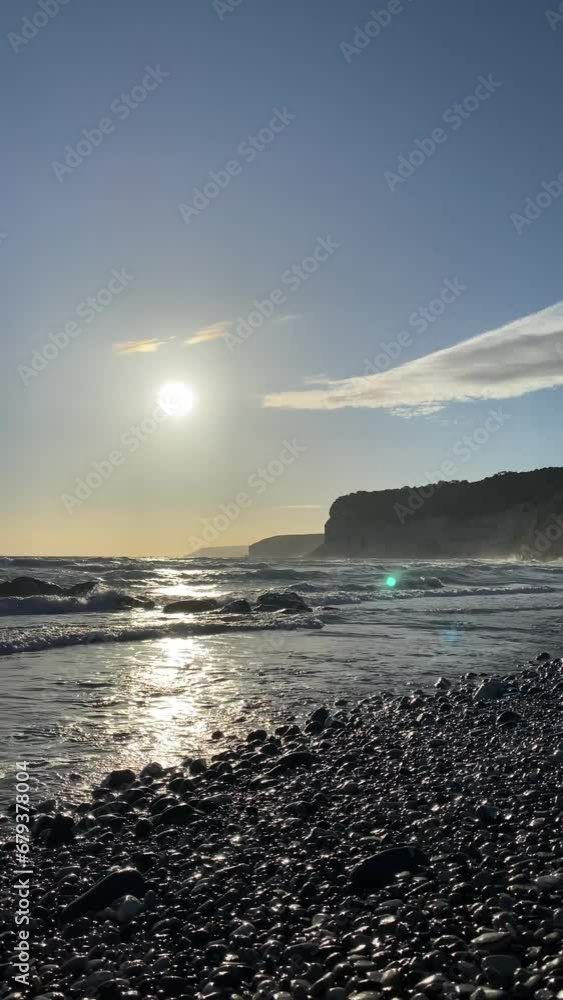 Dramatic early sunset at the beach with rocks Dramatic early sunset at the beach with rocks
