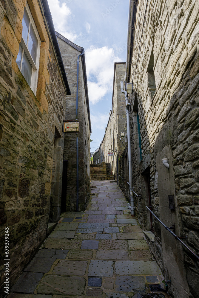 deserted alley in an English or Scottish city , town, or village in the United Kingdom