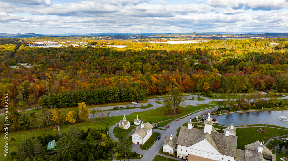 An Aerial View of Autumn Trees of Color Over Countryside, Sun and Shadows