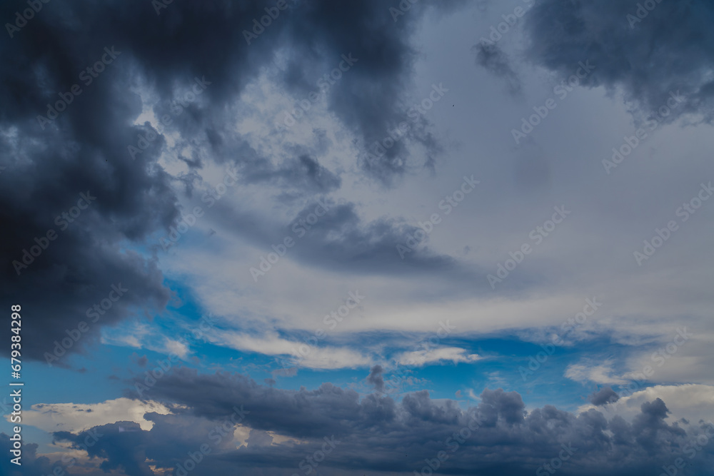 Obraz premium Rainclouds cover the blue sky