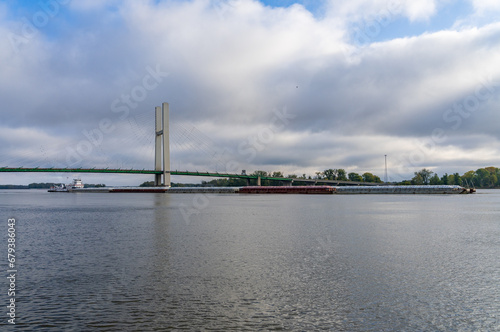 Aerial panorama of a large barge under the Great River Bridge across Mississippi between Burlington Iowa and Illinois © steheap