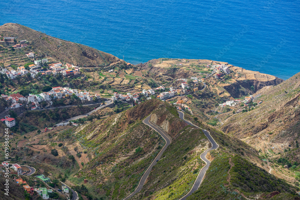 Obraz premium The Anaga massif (Macizo de Anaga). Natural landscape of the north of Tenerife and the small town of Taganana. Canary Islands. Spain. View from the observation deck - Mirador Bailadero.
