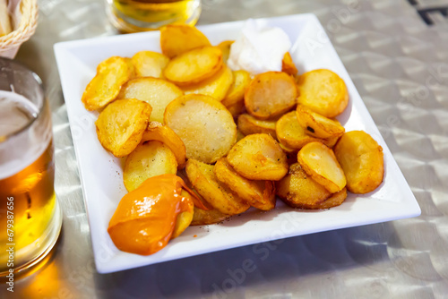 Dish of Spanish cuisine Patatas Bravas – fried potato with various sauces
