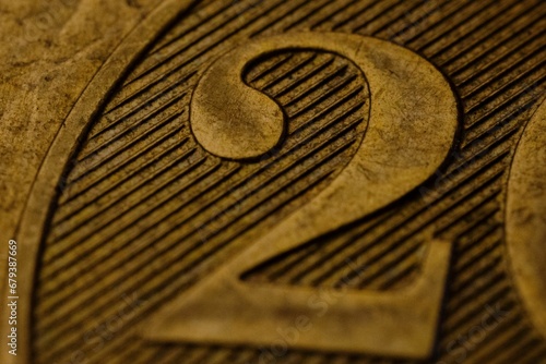 close up of a two dollar coin showing the numeral photo