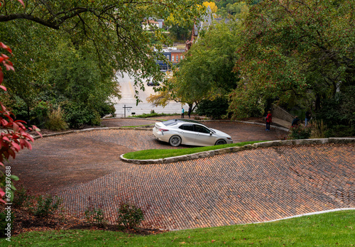 Car driving down Snake Alley in Burlington Iowa which has the world record for steepest bendy street