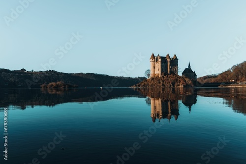 Castle of Val on a peninsula in an artificial lake in Lanobre, France. photo