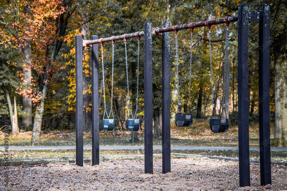 Empty playground in a park with swings