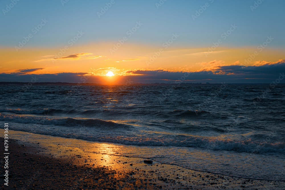 Scenic view of sunset over the sea waves