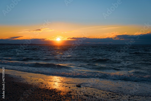 Scenic view of sunset over the sea waves