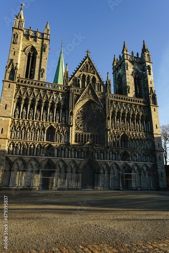 there is a large stone cathedral with two towers and a green spire