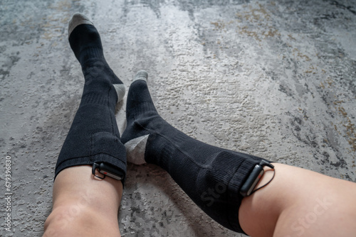 woman wears battery powered heated socks for cold winter