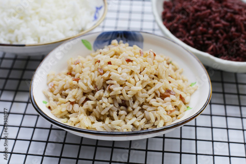 Cooked white, brown, black rice in bowl