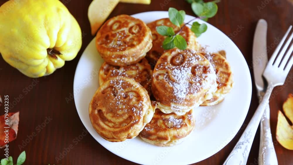 Cooked fried round pancakes with quince filling on a wooden table Cooked fried round pancakes with quince filling on a wooden table