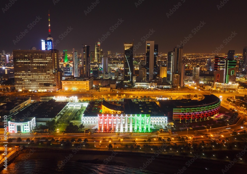 the cityscape is lit up with colorful lights and building in the background