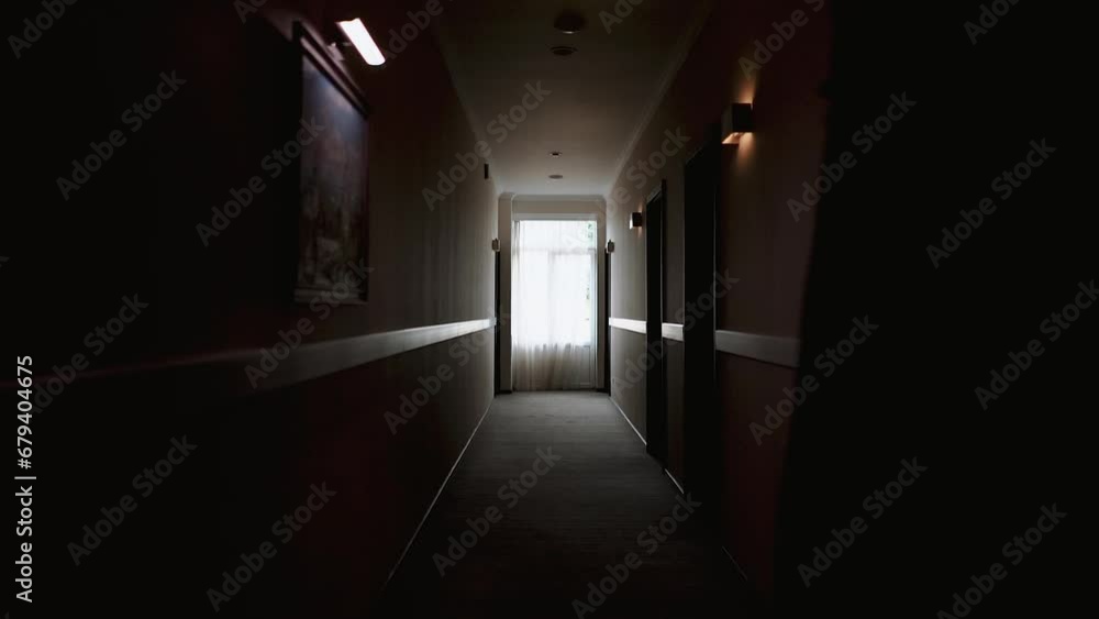 a dark black corridor and a room along which a man in a jacket and a classic suit walks, a businessman and a gentleman go to a business meeting in the office a dark black corridor and a room along which a man in a jacket and a classic suit walks, a businessman and a gentleman go to a business meeting in the office