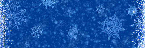 Blue Merry Christmas background with blurred lights.