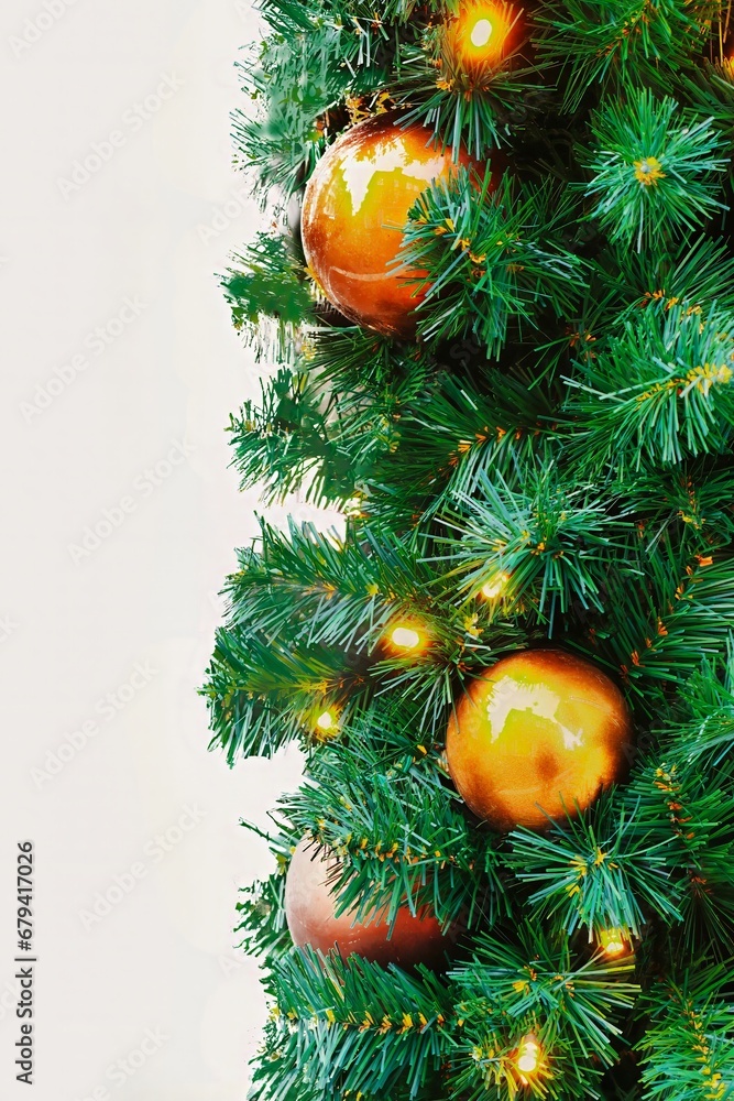 an isolated picture of pine christmas tree branches with orange decorations and lights an isolated picture of pine christmas tree branches with orange decorations and lights