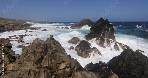 Epic, foaming waves crashing on rocky shore
