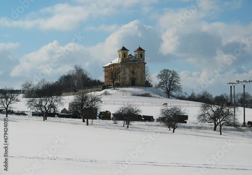 Church of St. Katerina in the Chotec countryside near Prague. Czechia. Cultural monument under reconstruction, winter snowy scenery. Catholic church from the 16th century. photo