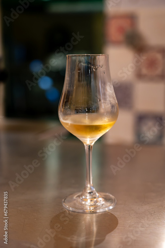 Tasting of cognac spirit aged in old French oak barrels in cellar in distillery in Cognac white wine region  Charente  Segonzac  Grand Champagne  France