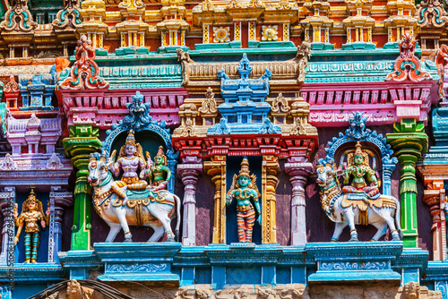 Shiva and Parvati on bull images. Sculptures on Hindu temple gopura tower. Meenakshi Temple, Madurai, Tamil Nadu, India