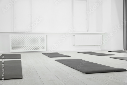 Spacious yoga studio with exercise mats on floor