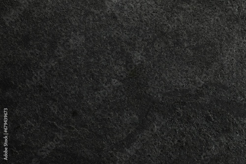 Texture of dark grey stone surface as background, closeup