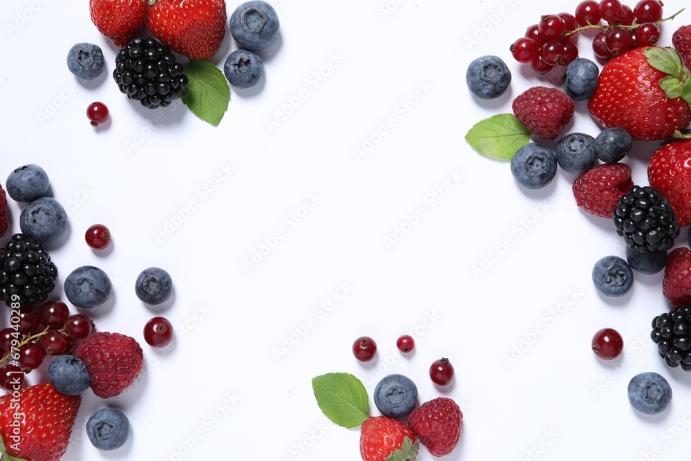 Many different fresh berries and mint leaves on white background, flat lay. Space for text Many different fresh berries and mint leaves on white background, flat lay. Space for text