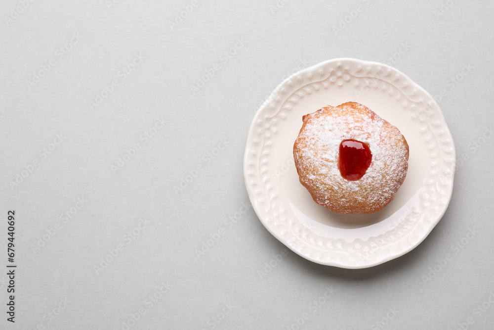 Hanukkah donut with jelly and powdered sugar on light grey background, top view. Space for text Hanukkah donut with jelly and powdered sugar on light grey background, top view. Space for text