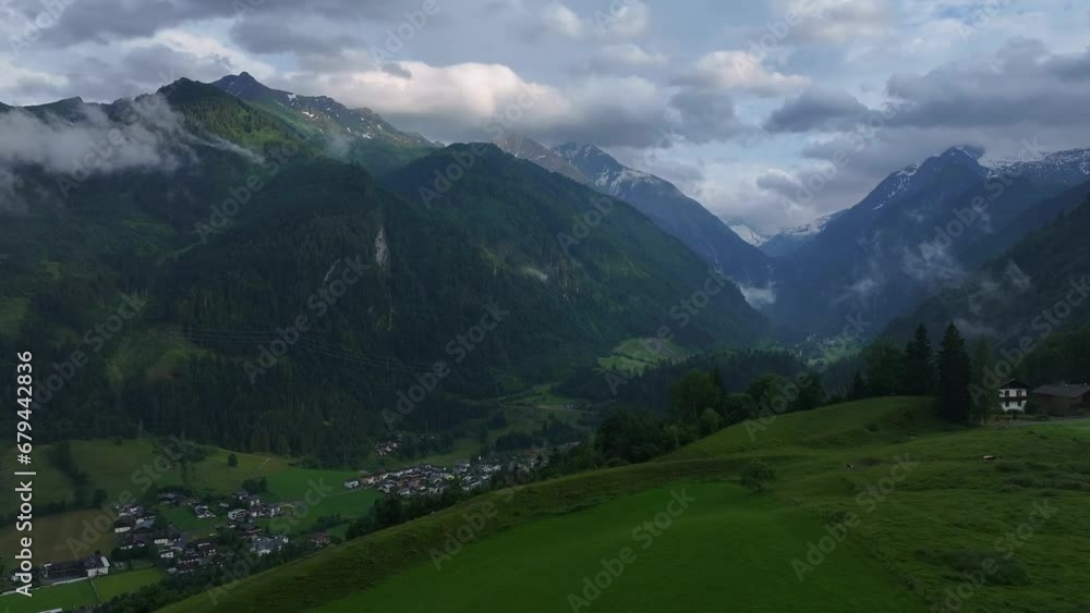 Skyline of cloud and fog cover mountainous range and settlement below Skyline of cloud and fog cover mountainous range and settlement below