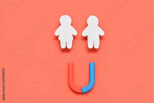 Fotografi Couple made of paper with magnet on red background