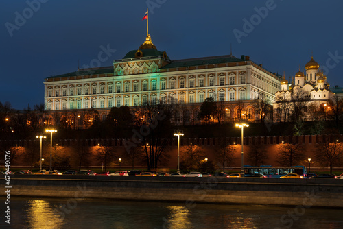 View of the building of the Grand Kremlin Palace and the ensemble of the Kremlin Cathedral Square from the embankment of the Moskva River with night lighting, Moscow, Russia