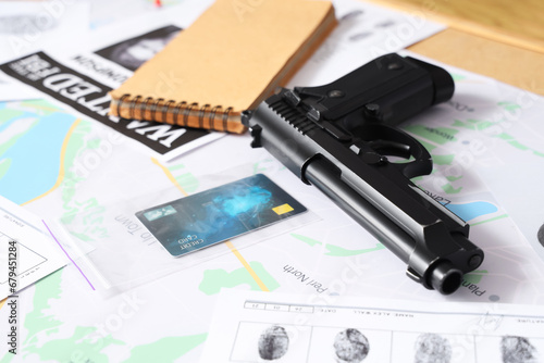 Gun with clues on table of FBI agent in office, closeup