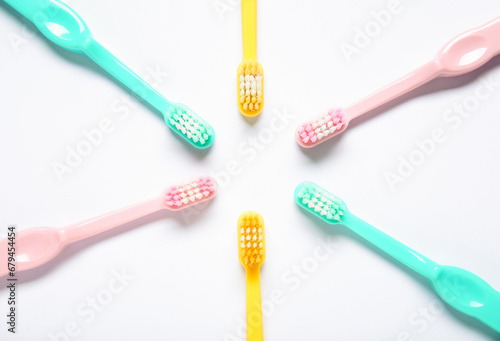 Colorful plastic toothbrushes on white background.